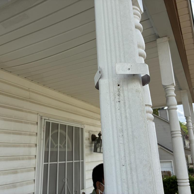 Front porch railing post with metal support braces