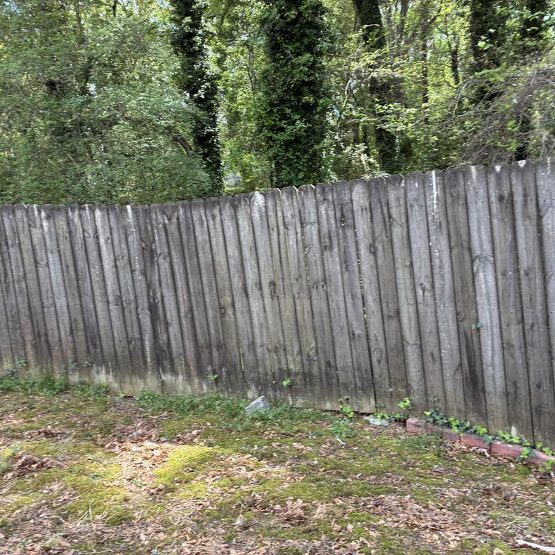 Privacy wood fence with weathered panels