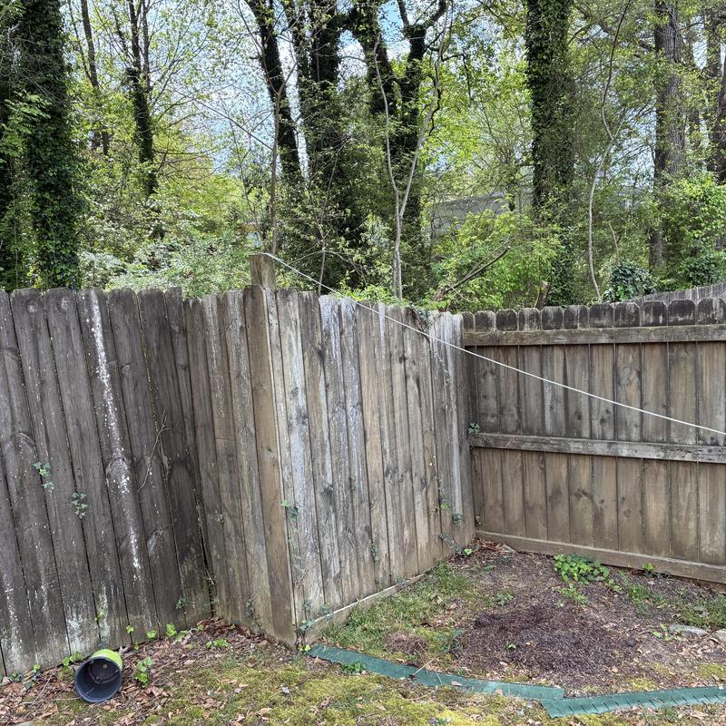 Privacy wood fence corner with weathered boards