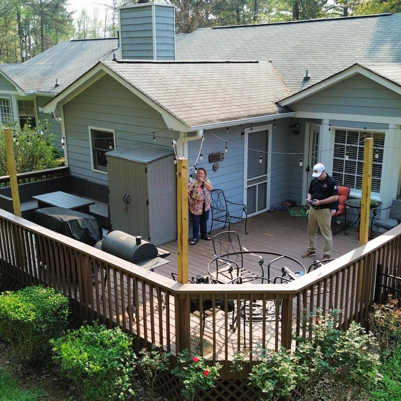 Shingle roof over deck with posts and string lights