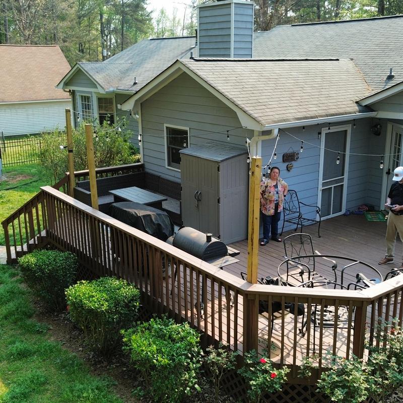 Shingle roof and wooden deck with string lights