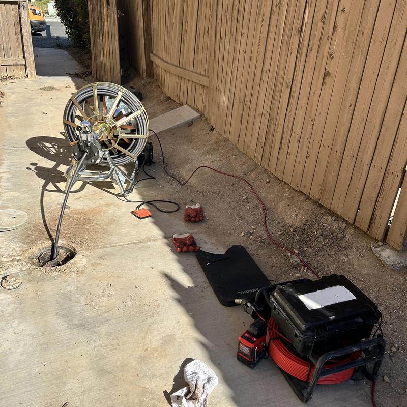 Sewer line drain machine clearing roots and clog
