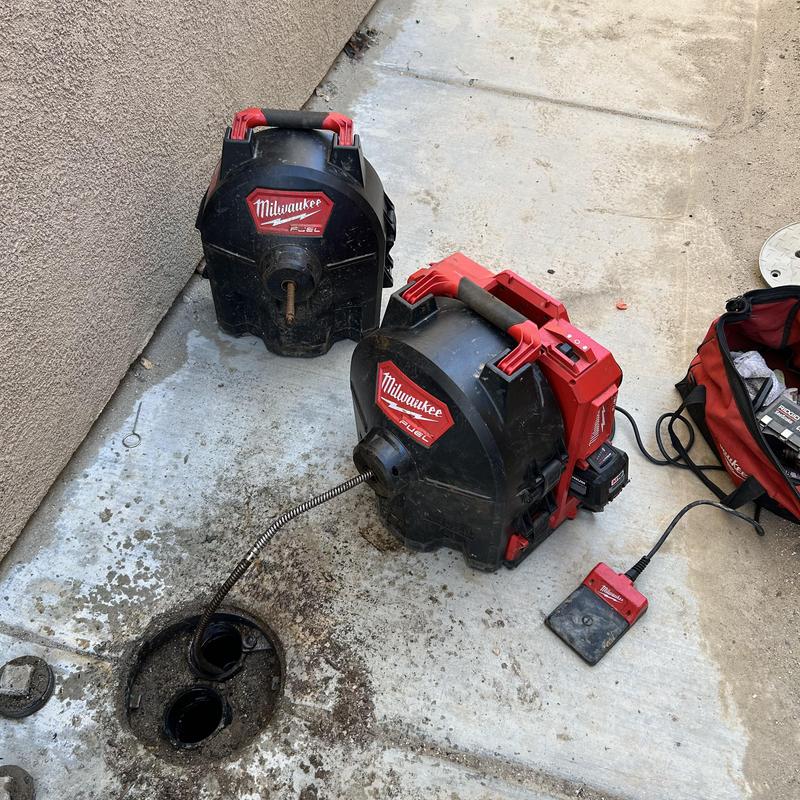 Sewer drain line with Milwaukee sewer machine clearing clog