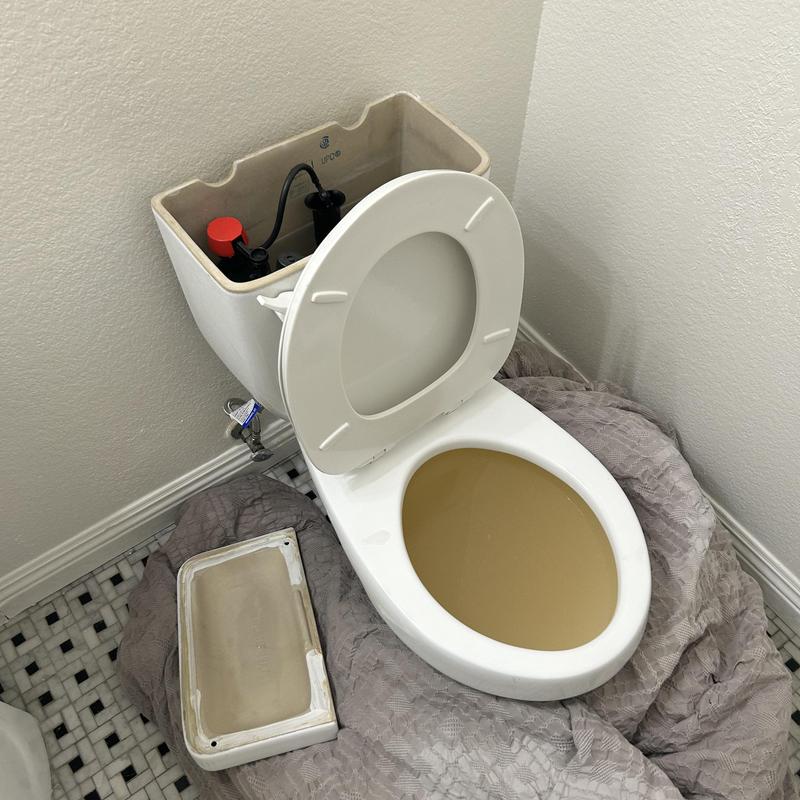 Toilet tank with lid removed for plumbing access