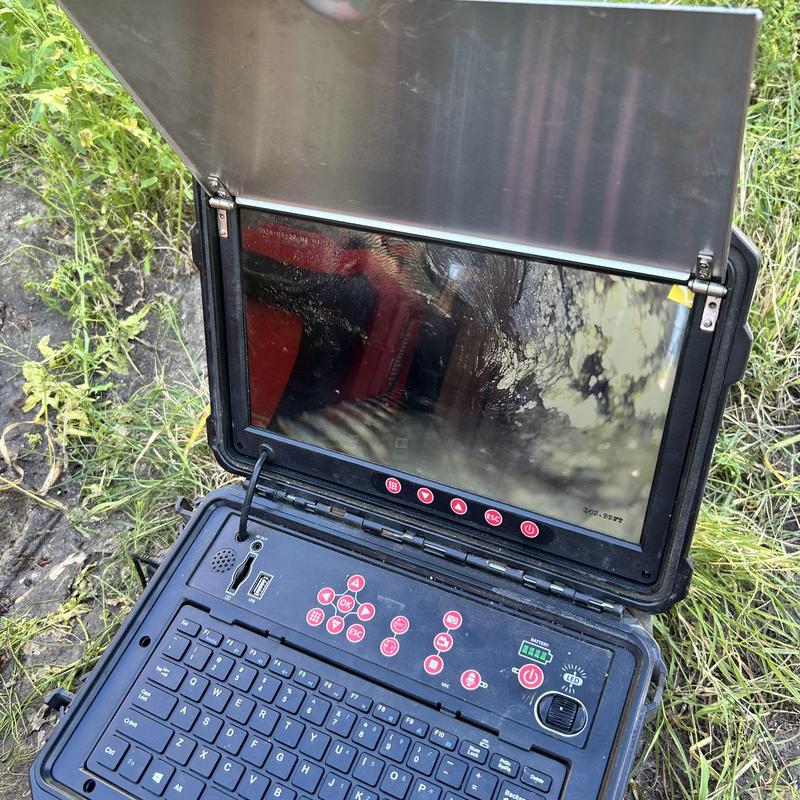 Sewer camera inspection monitor with controls outdoors