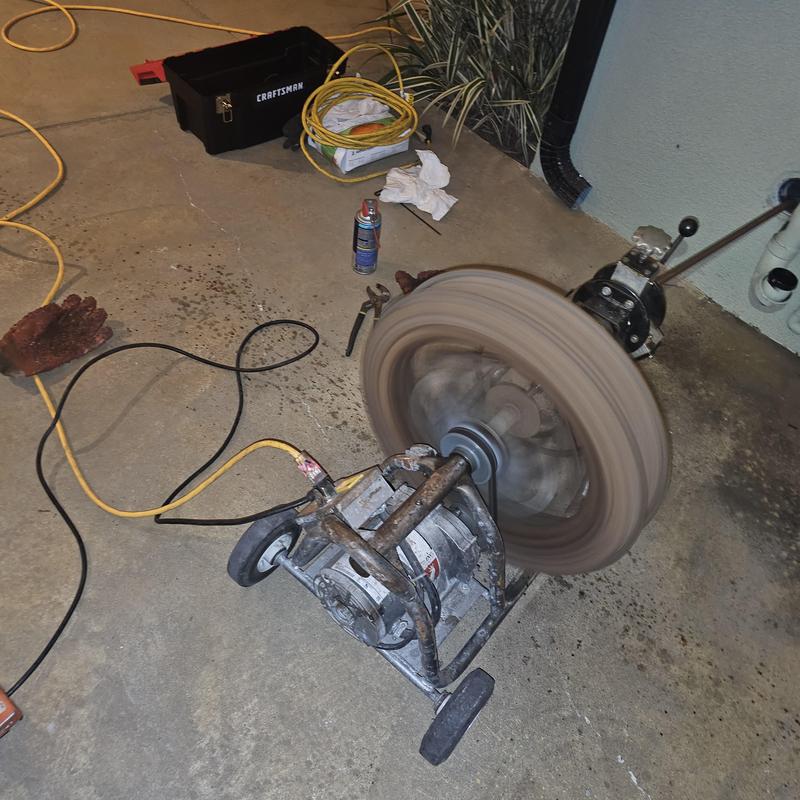 Sewer drain cleaning machine clearing blockage