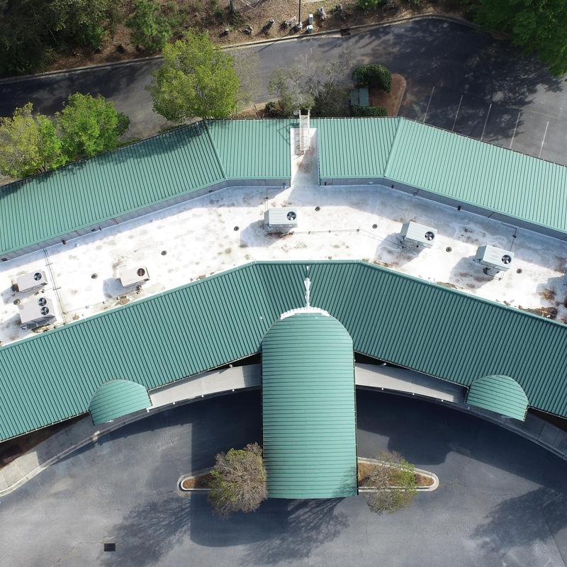 TPO roofing system with parapet wall seams and flashing issues