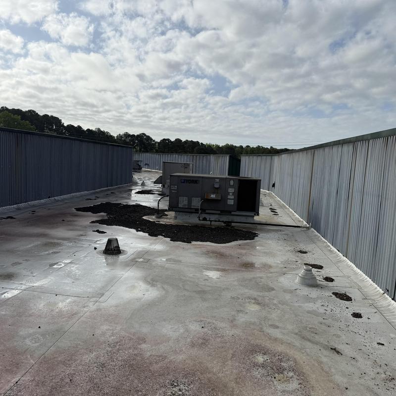 TPO roofing with damaged patches and rooftop HVAC unit