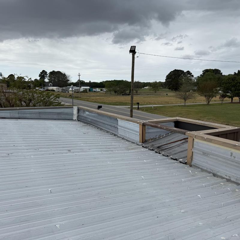 Metal roof and parapet wall with drainage issues
