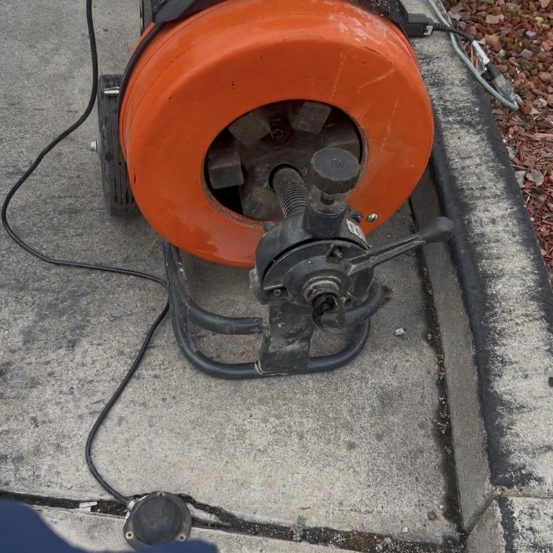 Grease main drain snake machine on concrete surface Grease main drain snake machine on concrete surface