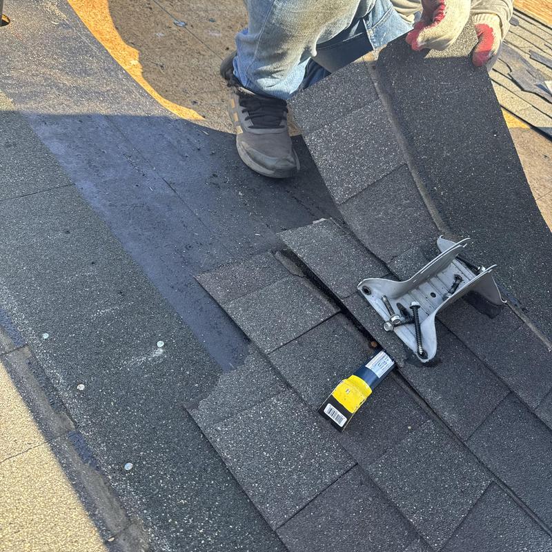 Asphalt shingles installation with roofing tools on deck Asphalt shingles installation with roofing tools on deck