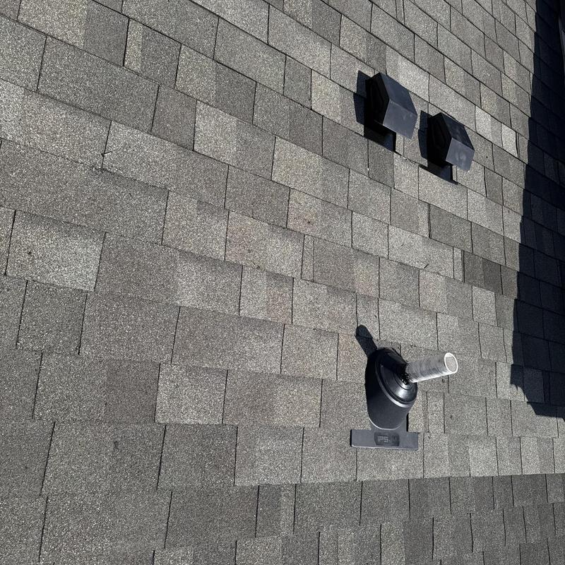 Roof vent flashing and shingle installation on asphalt roof Roof vent flashing and shingle installation on asphalt roof