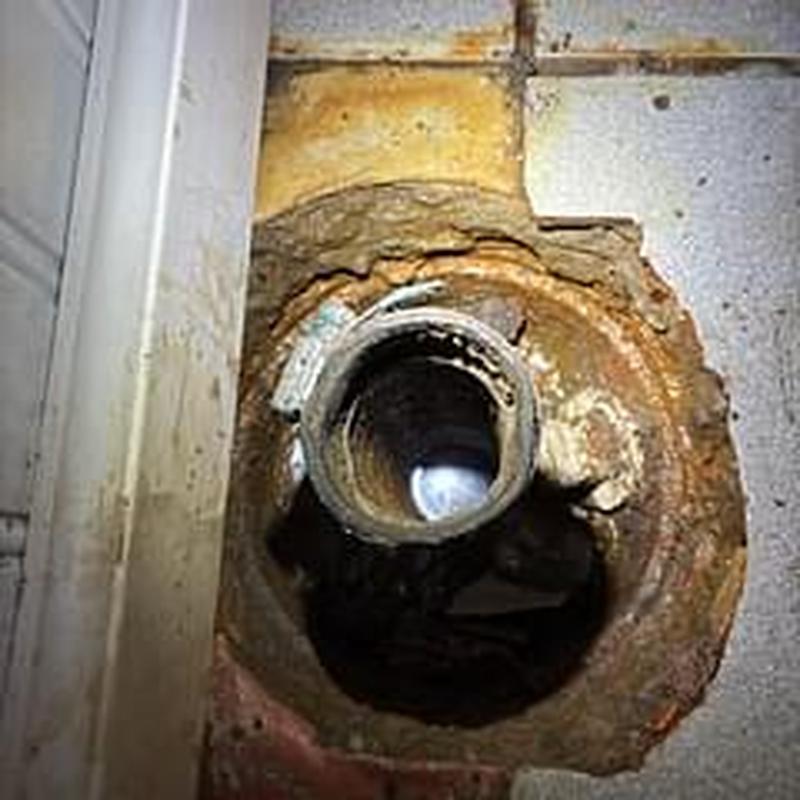 Basement floor drain pipe with rust and debris clearance