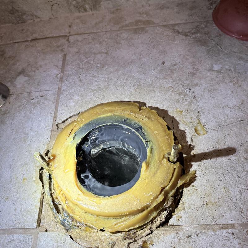 Toilet flange with cleared clog and sealant residue Toilet flange with cleared clog and sealant residue