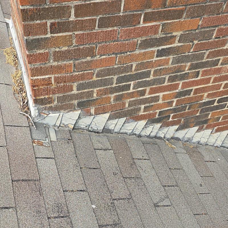 Chimney metal flashing with wind and hail damage