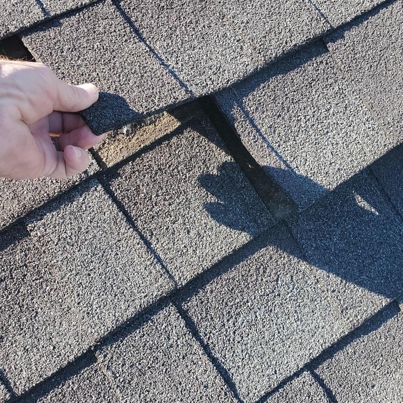 Asphalt roof shingles with wind and hail damage inspection