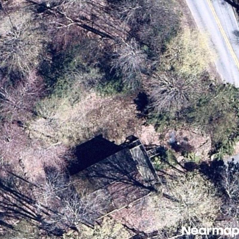 Roof system aerial view with surrounding trees and road Roof system aerial view with surrounding trees and road