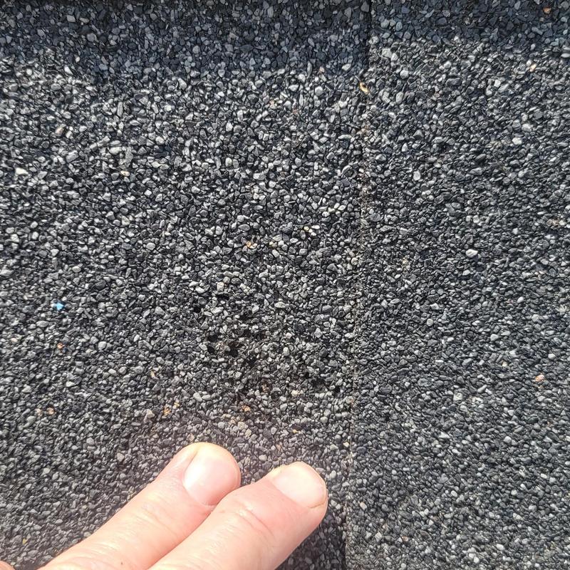 Asphalt shingle roof with hail damage close-up