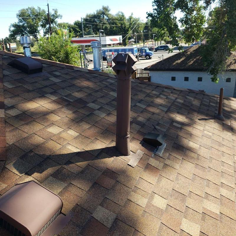 Shingle pipe jack with sealed storm collars on roof