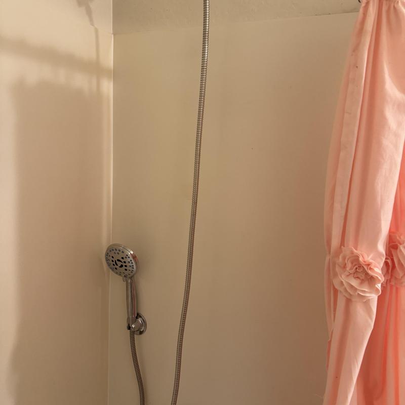 Showerhead and hose installation in bathroom corner Showerhead and hose installation in bathroom corner