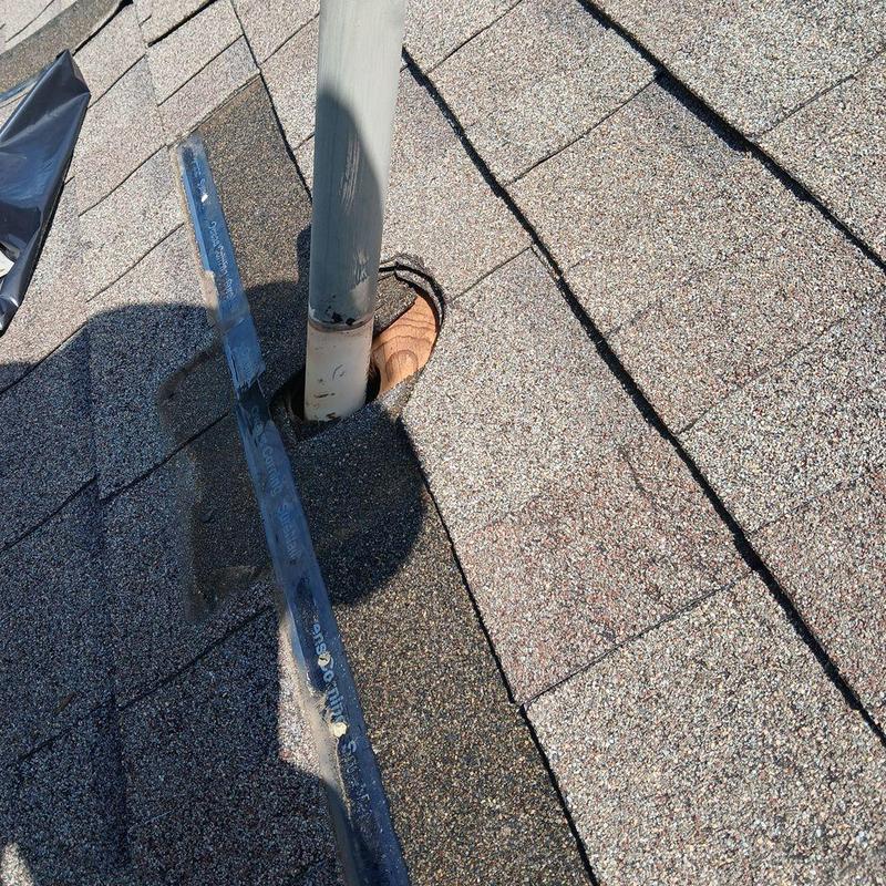 Neoprene pipe boot on asphalt shingle roof installation