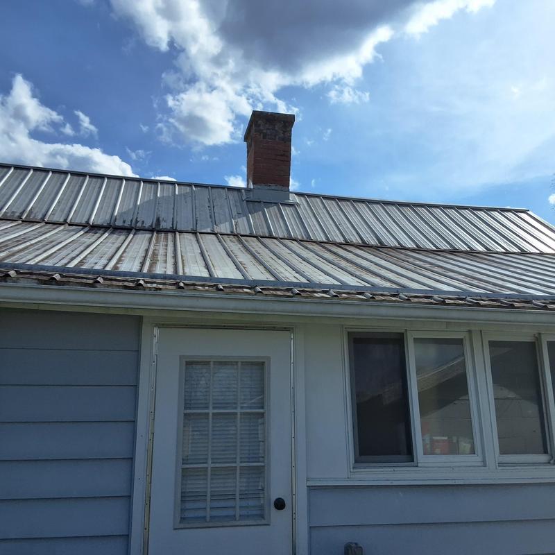 Metal roof with chimney on residential building