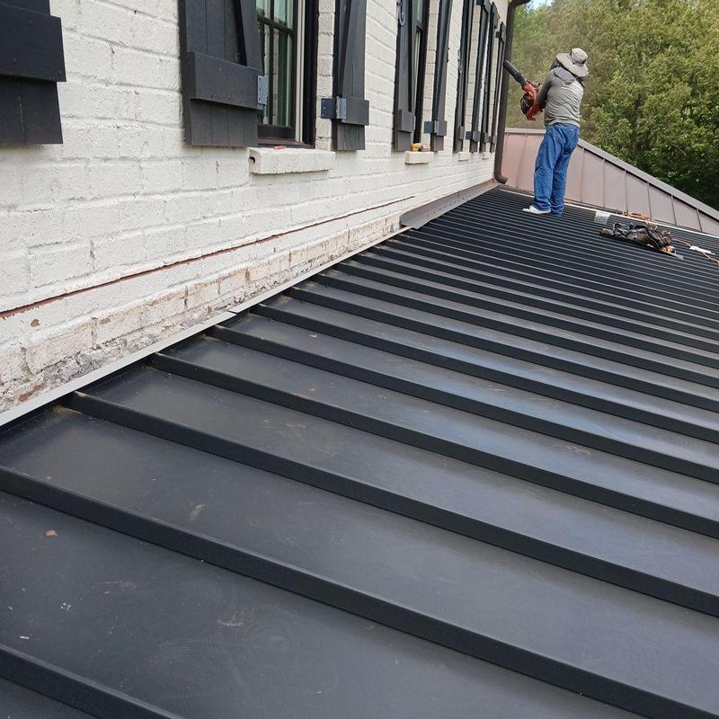 Standing seam metal roof with counter flashing installation