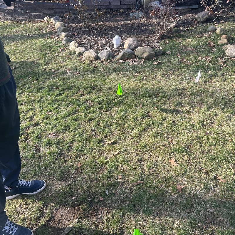 Sewer line access locators in residential yard Sewer line access locators in residential yard