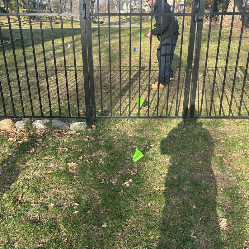 Sewer line markers flagged along fenced yard in Fairfield, NJ Sewer line markers flagged along fenced yard in Fairfield, NJ