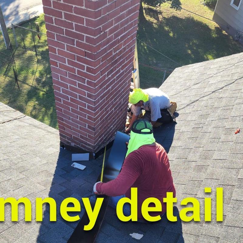 Chimney flashing installation on asphalt roof