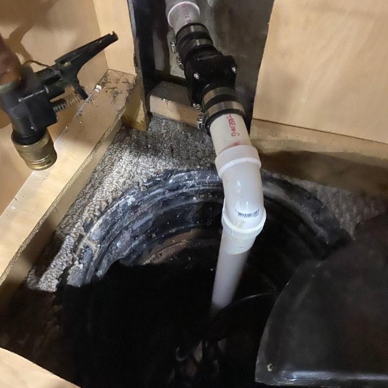 Sump pump and discharge pipe installation in basement pit
