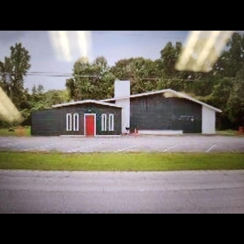 Commercial building roof exterior with red door