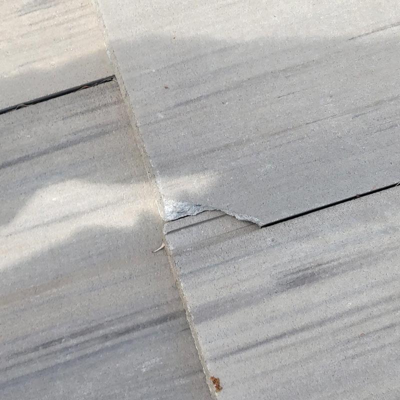 Tile roof with damaged broken tile close-up