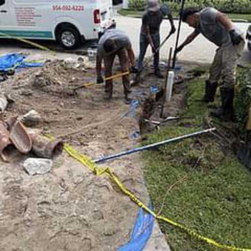 Broken clay sewer pipe excavation and repair workers