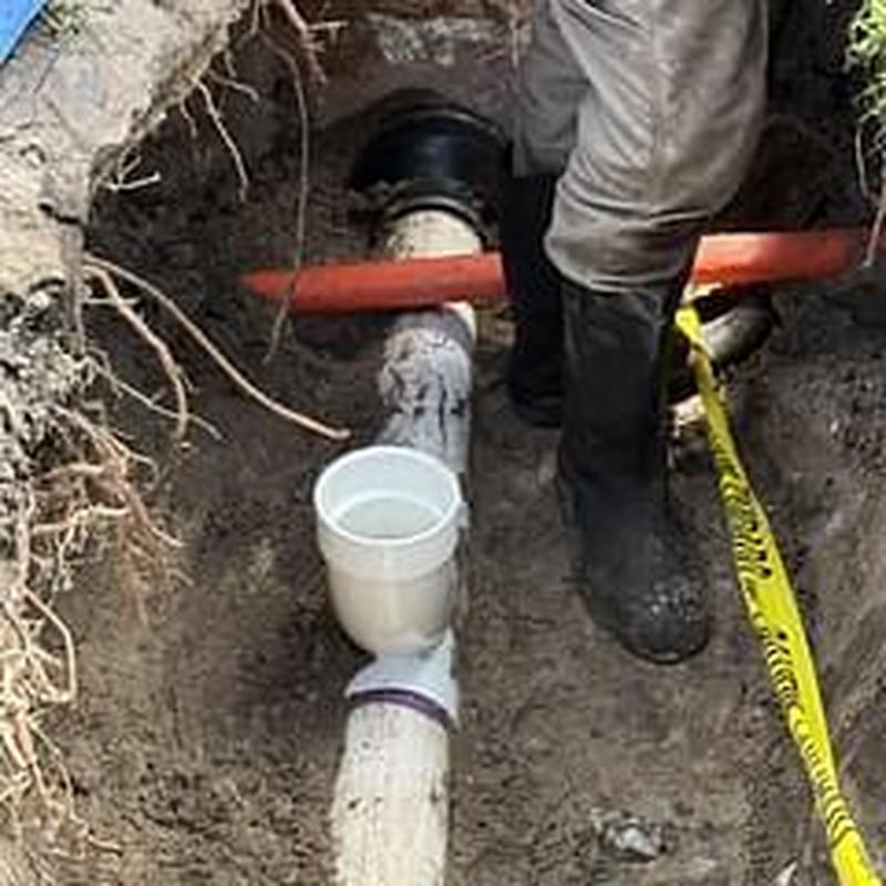 Clay sewer pipe excavation and repair with fiber optic cable nearby
