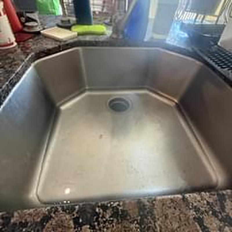 Kitchen sink drain clearing with power auger cable