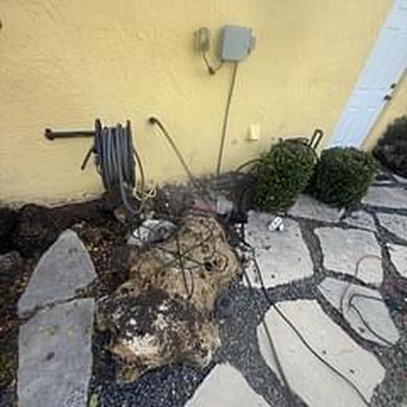 Laundry cleanout power auger clearing buildup outdoors