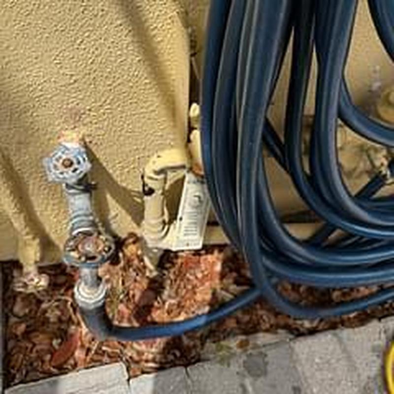 Backflow device with attached hoses and valves outdoors