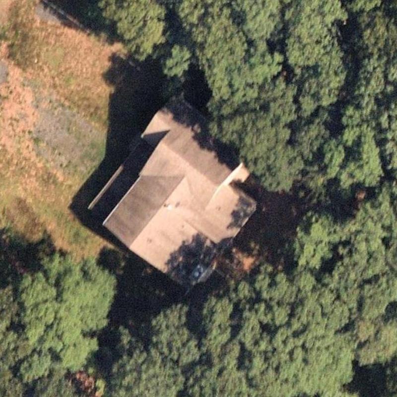 Roof shingles inspection on house surrounded by trees Roof shingles inspection on house surrounded by trees