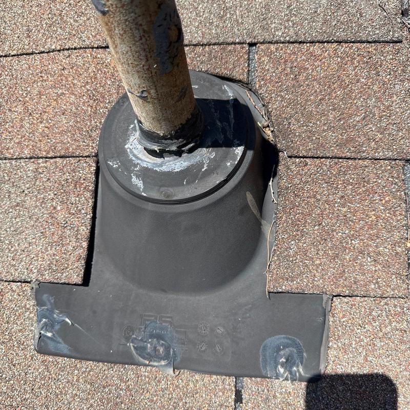 Roof pipe flashing with cracked shingle sealant