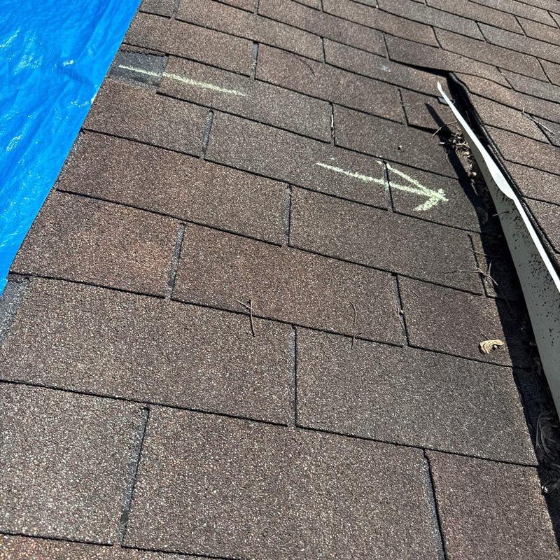 Asphalt shingles with hail damage and chalk marking