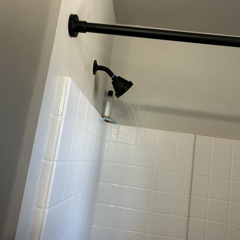 Showerhead with improved water pressure in white tiled shower