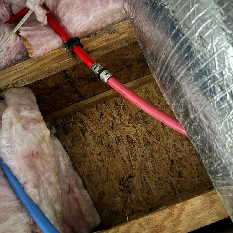PEX water pipes with insulation and ductwork in attic