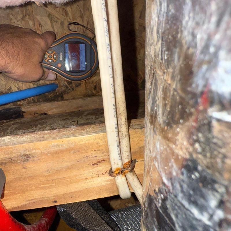 PVC water pipes with moisture meter reading in crawl space