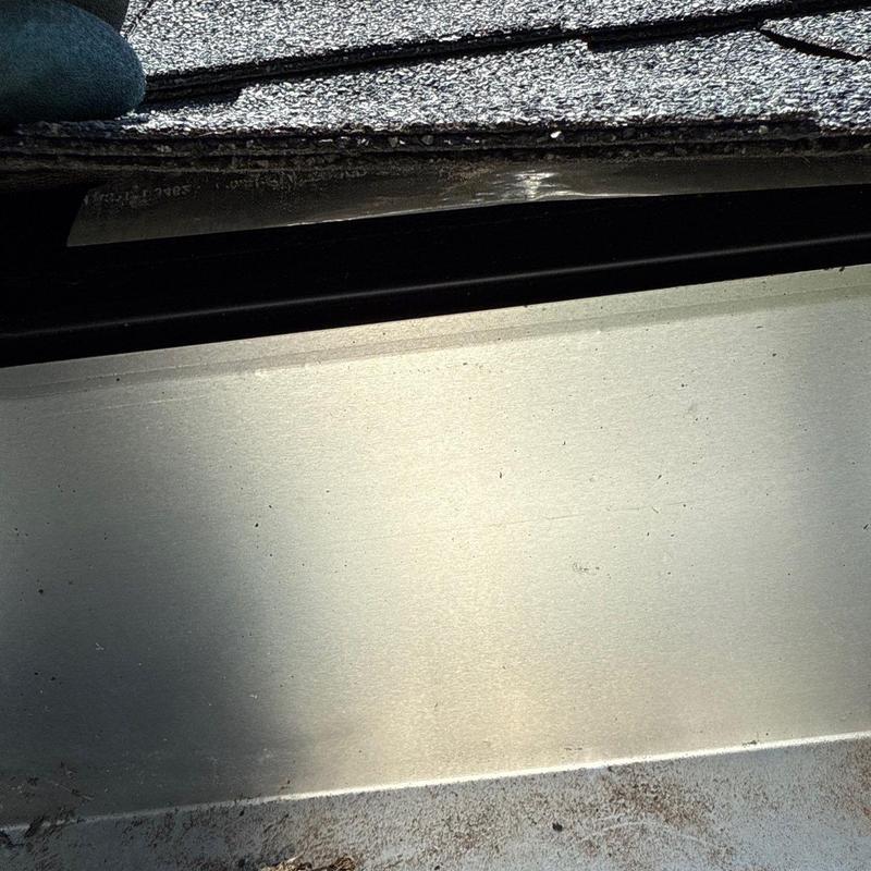 Shingle edge with visible damage near gutter system