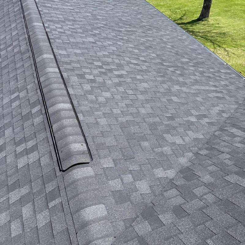Asphalt shingle roof with ridge cap and vent system