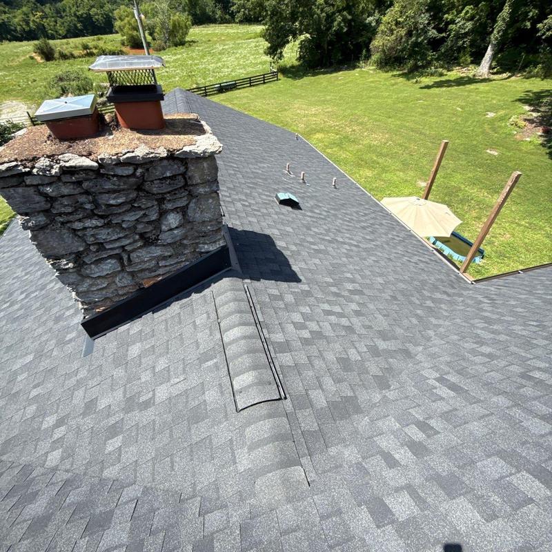 Asphalt shingle roof with chimney and vent pipes