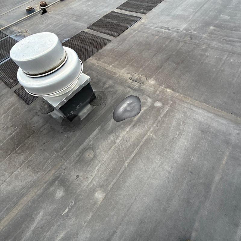 Commercial roof membrane with hail damage and repairs