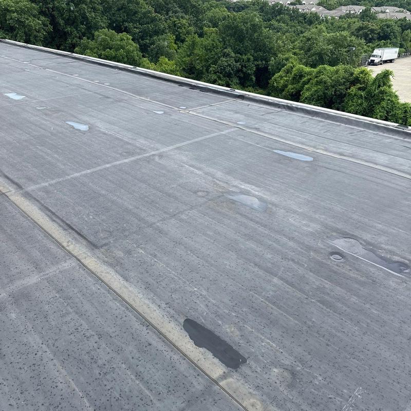 Commercial roof membrane with hail damage and impact marks