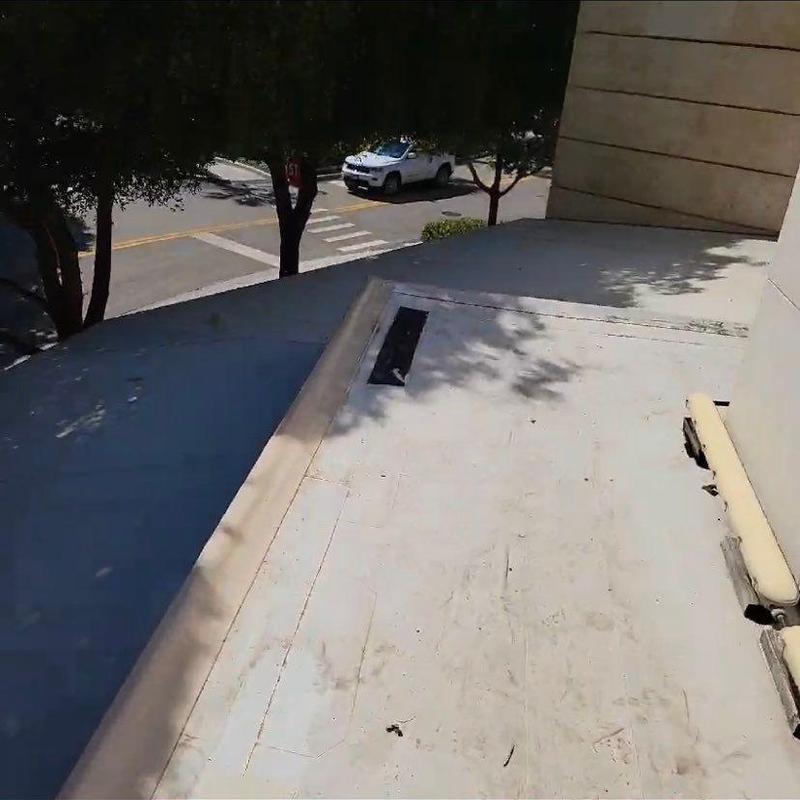 TPO roofing membrane with visible seam and flashing repairs